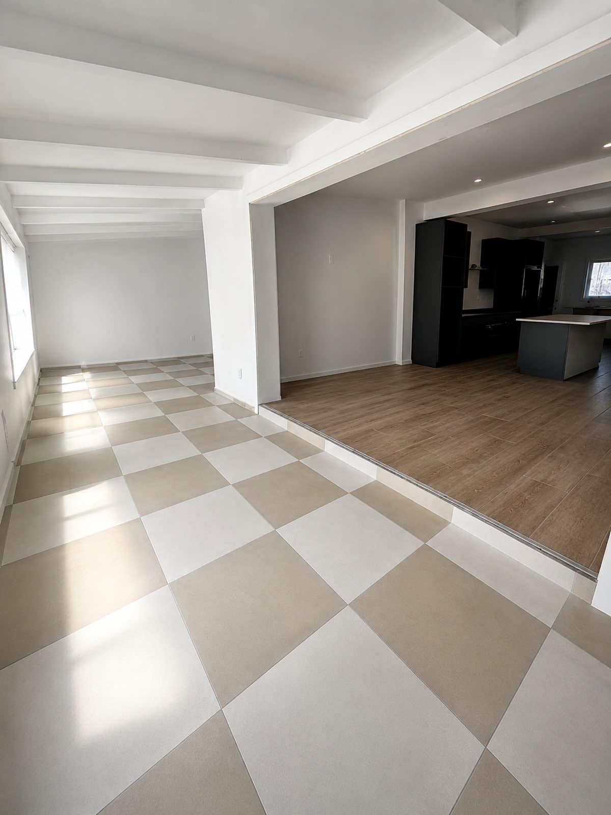 Open-plan room with checkerboard porcelain tile meeting wood-look plank